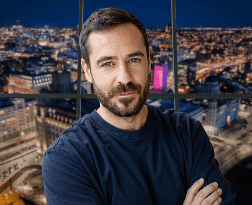 Jack Price, founder of SEOJack, in front of a city skyline at night